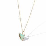Necklace with a opal pendant on a black textured surface